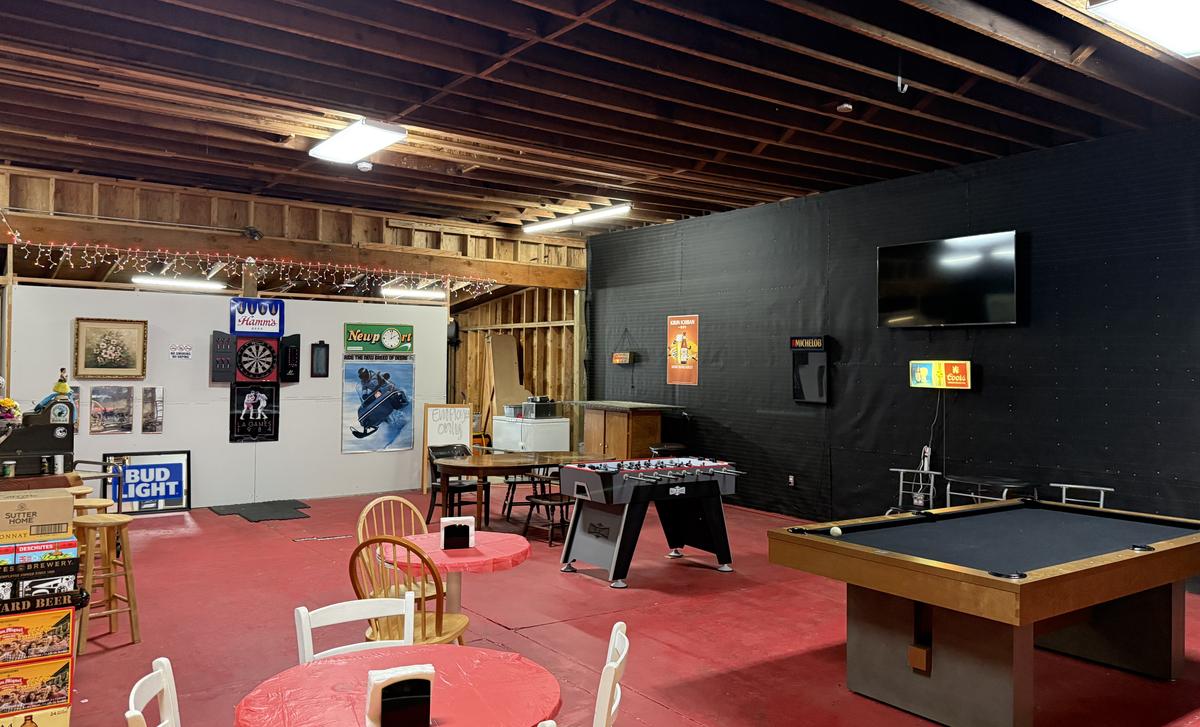 Game room with a pool table, foosball table and dart board