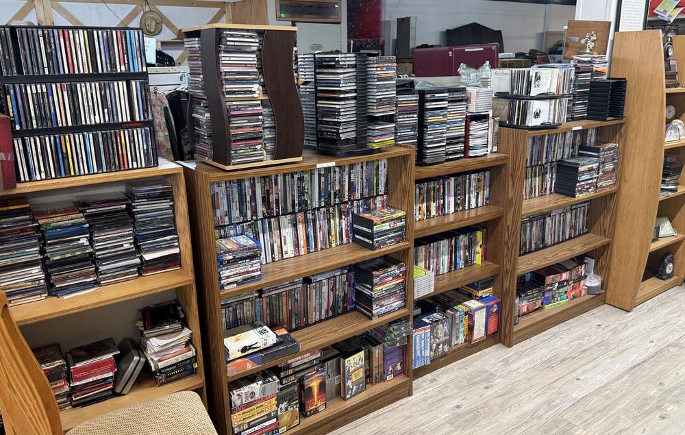 Shelves packed with DVDs, Blu-rays and stacks of CDs
