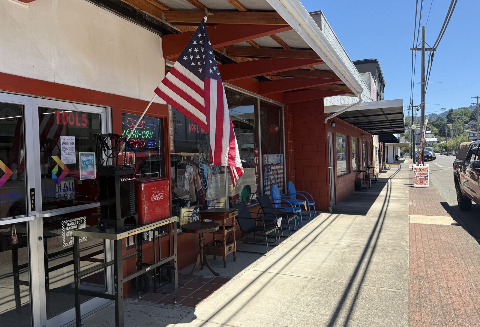DTF Trading storefront with an American flag and Books and Tools window lettering