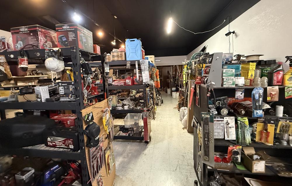 Shelves stocked with tools, jacks, hardware and shop supplies