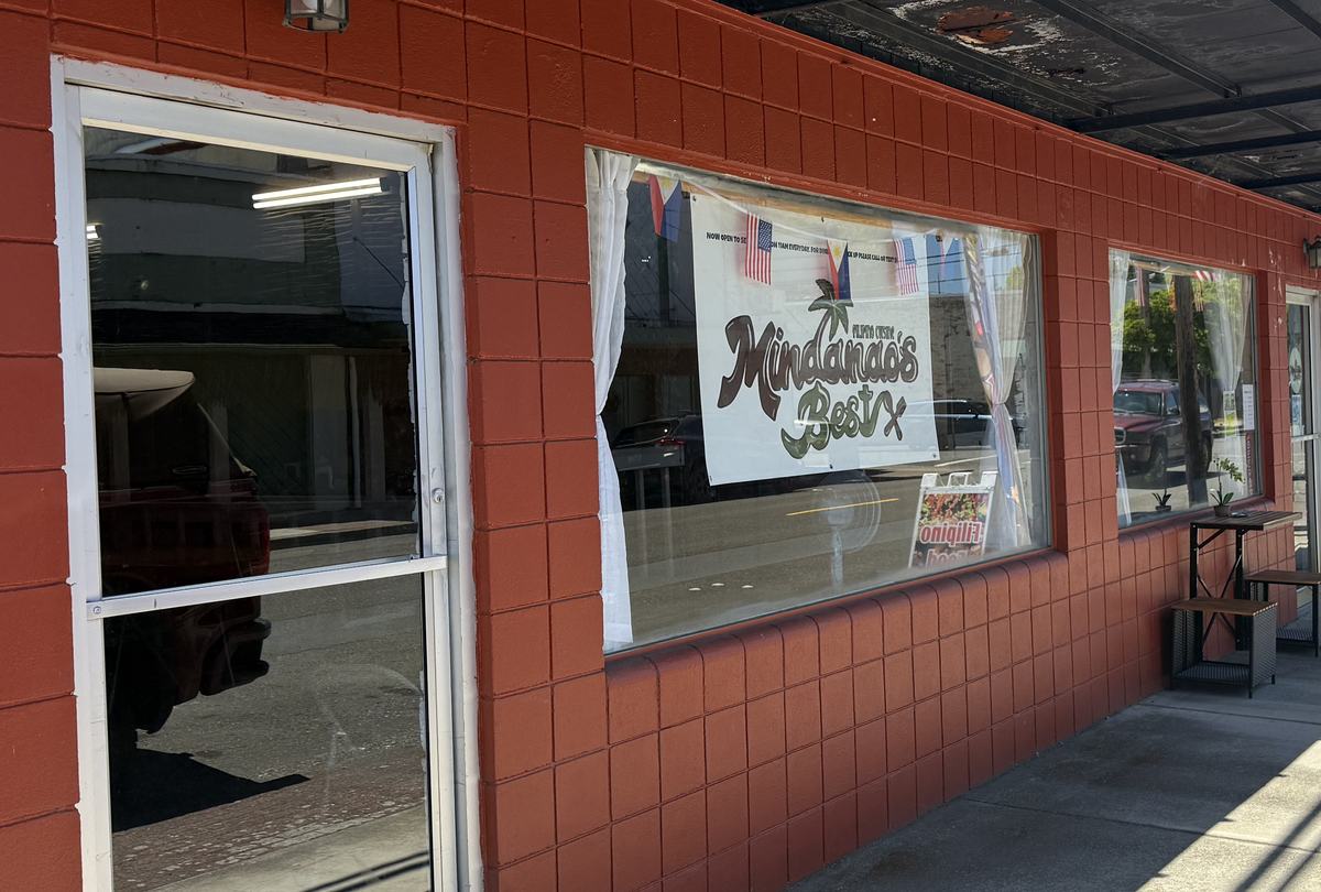 The Mindanao's Best hand lettered banner hanging in the window of the red brick building on Spruce Street